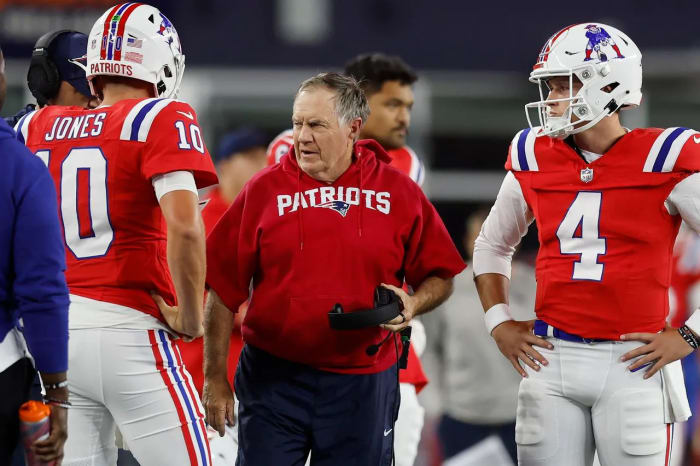 New England Patriots head coach Bill Belichick with quarterback Mac Jones (10) and quarterback Bailey Zappe (4)
